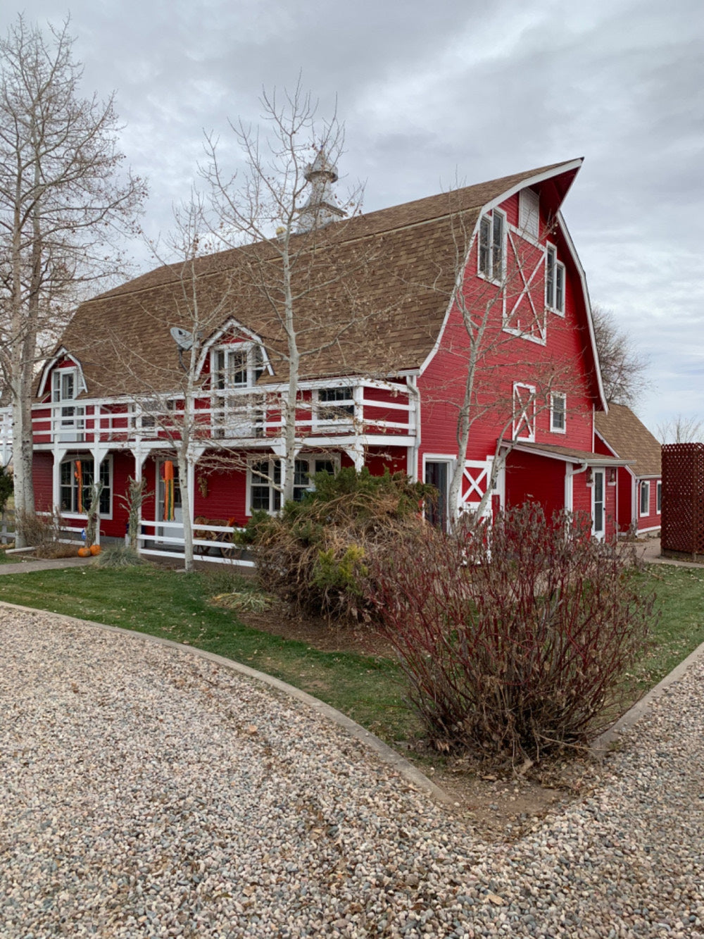 Red barn-style home with white trim